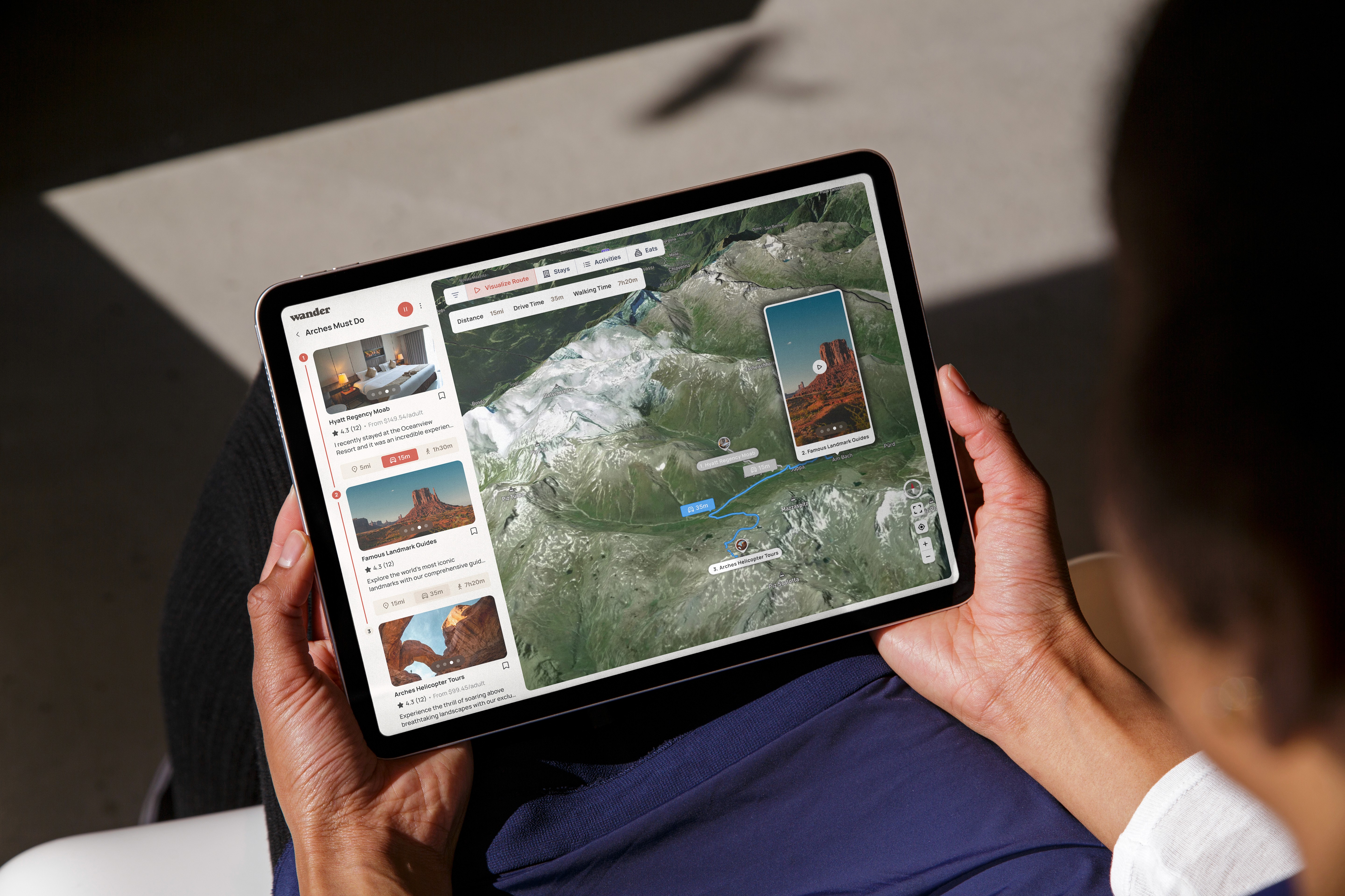 Person holding an iPad showing Wander with a saved list and 3D map route